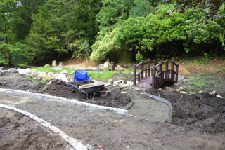 Johnny Clasper&#39;s stream replacement to the drain from the skate board park. Liz discussing the watercourse with the contractors,and Jonny working to improve the weir.